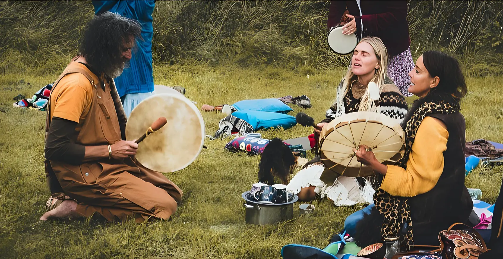 3 people singing together,drumming outdoors in nature.